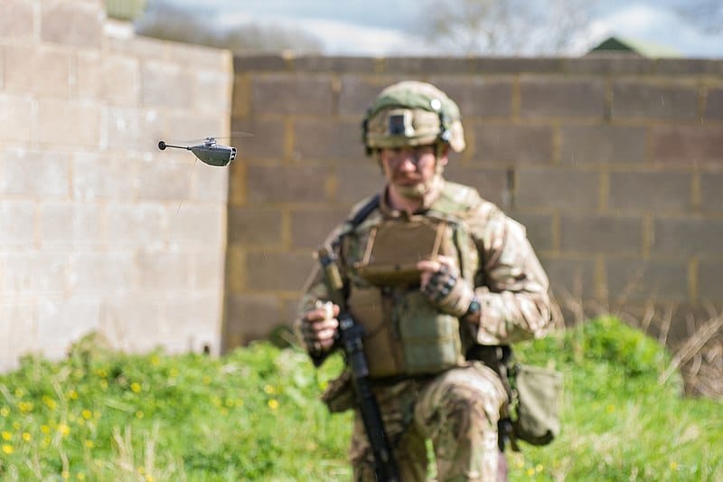 Royal Marine controlling a Black Hornet 2 Remotely Piloted Aircraft System (RPAS). It's a pocket-sized and hand-launched UAV, which is used in the field by military personnel for reconnaissance. It weighs 18 grams, uses micro thermal cameras, visible spectrum cameras and proprietary software for flight control, stabilisation, and communications. Source:  http://www.defenceimagery.mod.uk